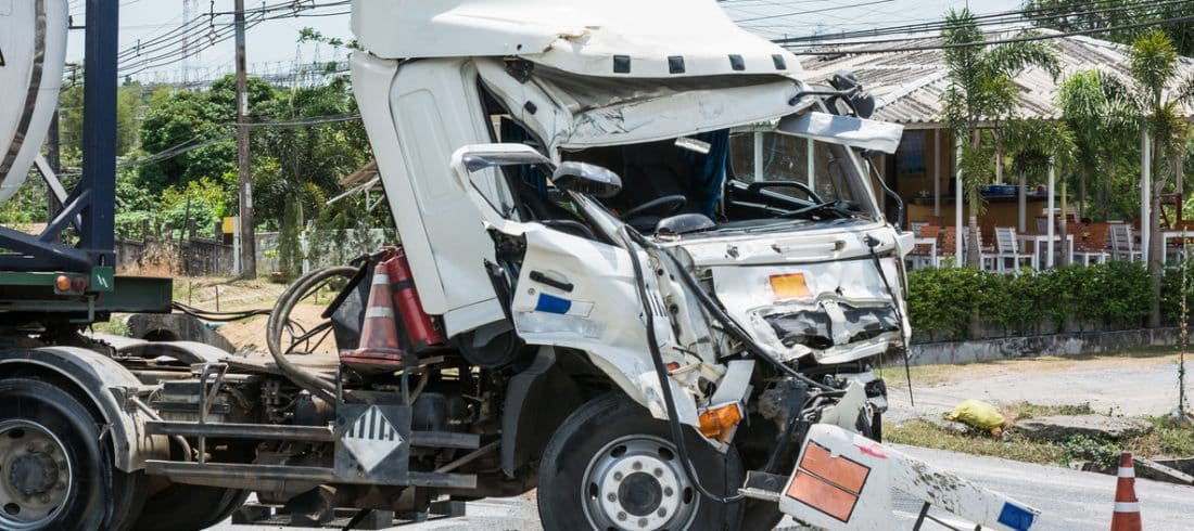 A semi truck with a damaged front frame after a truck accident