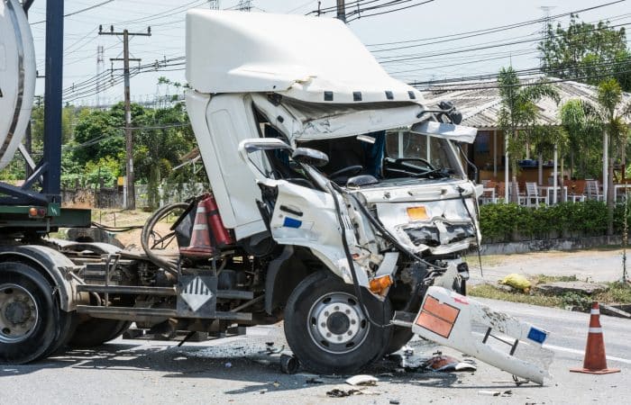 A semi truck with a damaged front frame after a truck accident