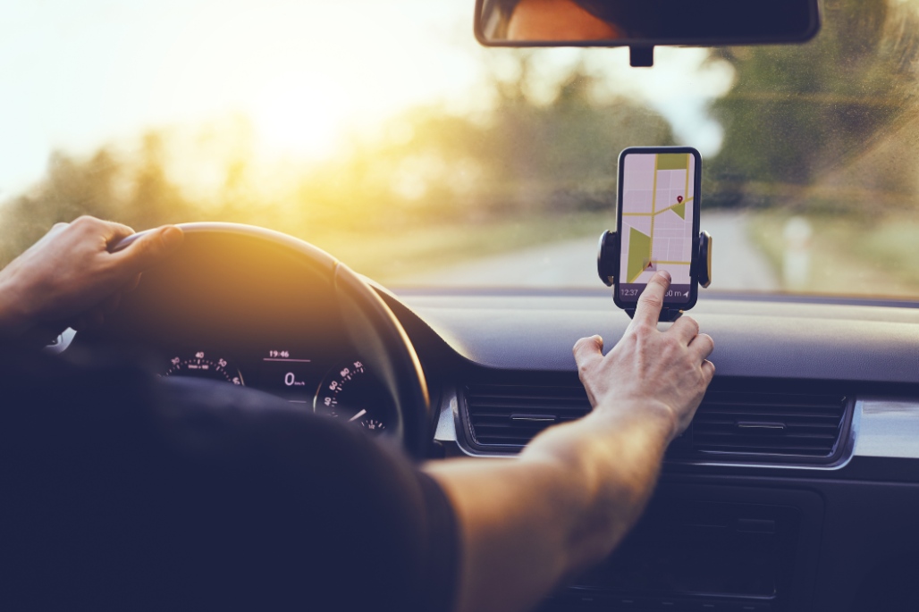 greenville car accident attorney - driver's hand extended to make changes to his GPS